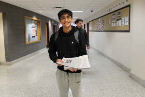  student holding newspapers